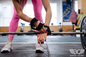 The girl puts on Figure-8 Straps to lift the barbell