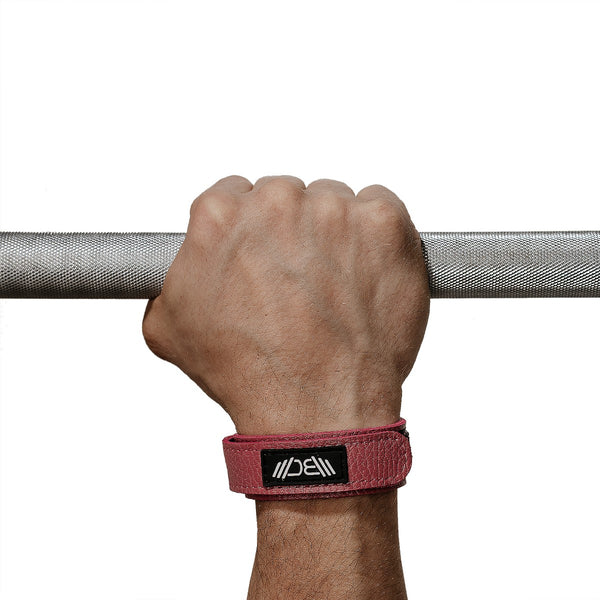 Leather Wrist Wraps Basic Pink on a hand holding a barbell – Warm Body Cold Mind