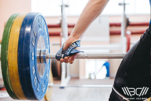 Man lifting a Barbell using Olympic Lifting Straps