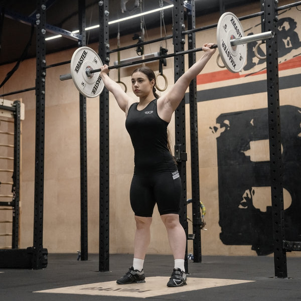 Person in WOMEN'S WEIGHTLIFTING COMPRESSION SINGLET S-4 lifting a barbell in a gym setting - Warm Body Cold Mind